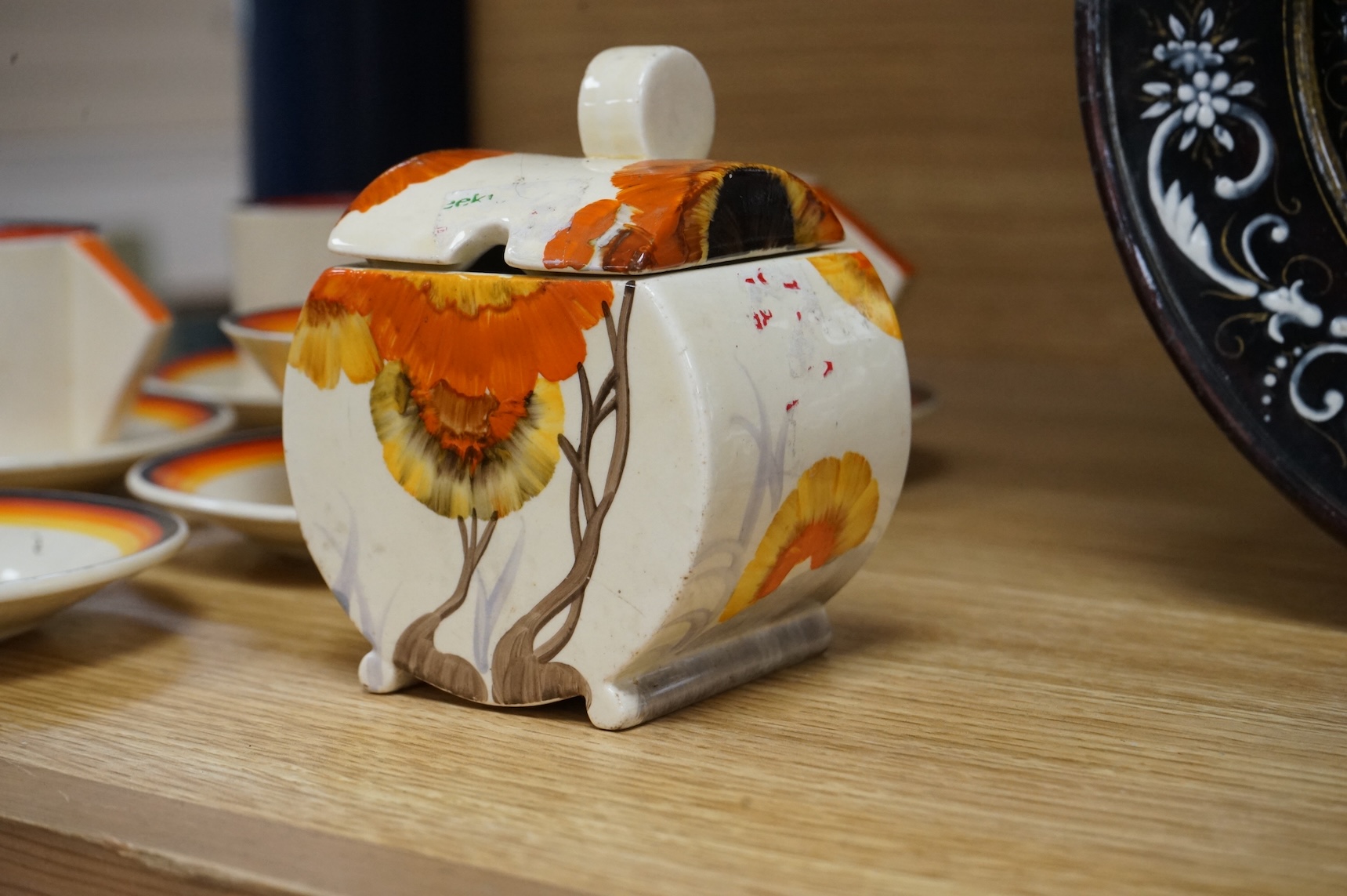 An Art Deco Clarice Cliff Bizarre part coffee set and a similar Rhodanthe-pattern preserve pot and cover, largest 11cm high